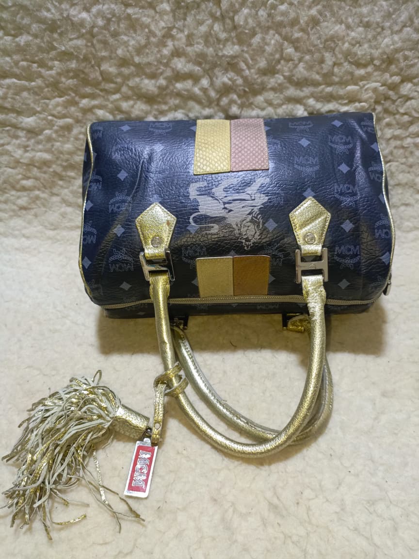 MCM Visetos Princess Lion Boston Bag – Black/Gold | Pre-Loved